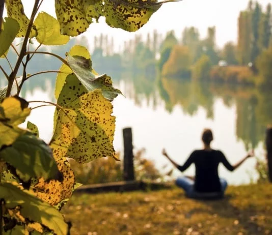 YogaFX Woman doing meditation in Autumn season