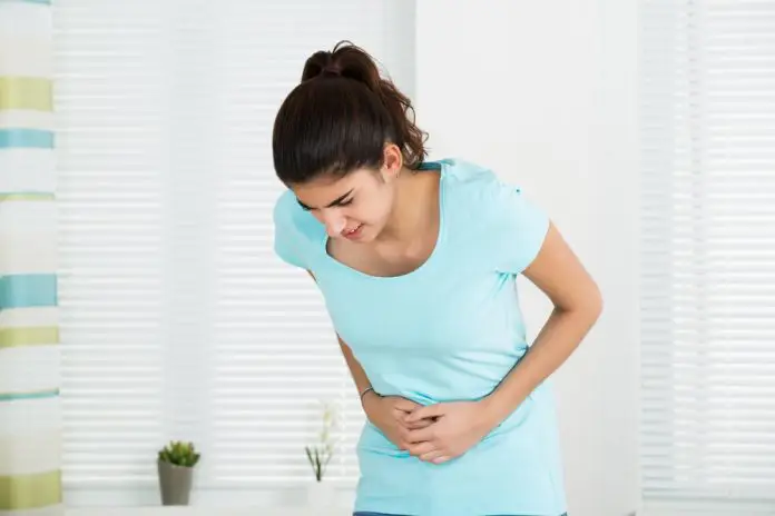 Woman Suffering From Stomach Ache At Home yoga for ibs