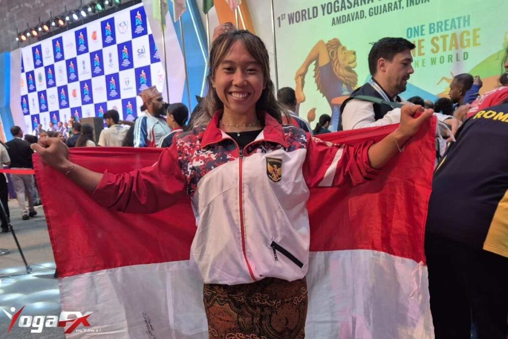 Ivara Candra Kartika YogaFX 2023 graduate holding gold and bronze medal at World Yogasana Sport Championship 2026