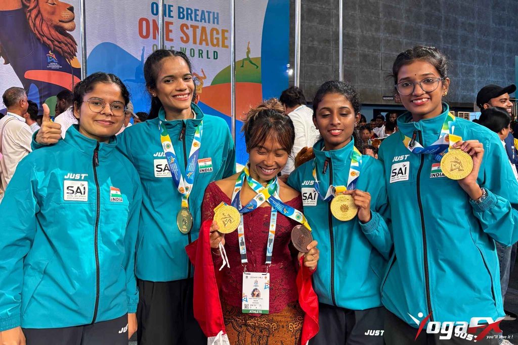World Yogasana Championship 2026: How Two YogaFX Graduates Won 7 Medals 1 Ivara Candra Kartika, 2023 YogaFX RYT 200 graduate, holding gold and bronze medals from the World Yogasana Championship 2026 in Ahmedabad, India