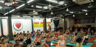 Yoga teacher training students practicing hot yoga postures in Bali's natural tropical heat, never an electric heater, during a 6-day intensive retreat