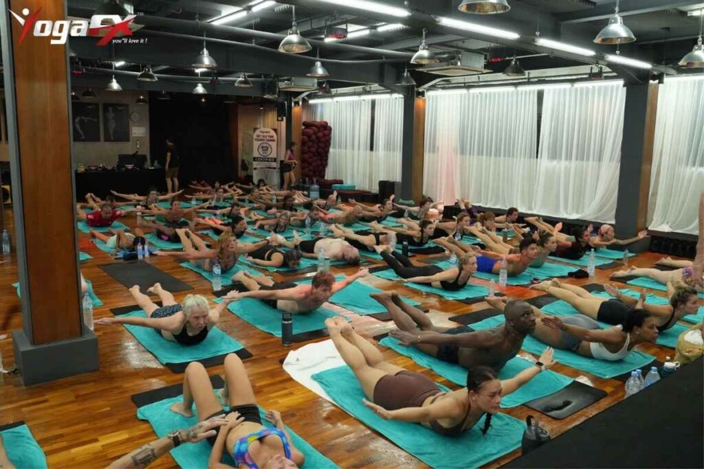 200-Hour Yoga Teacher Training Retreats: Intensive vs Multi-Week 2 Yoga teacher training cohort practicing dialogue delivery and teaching correction, the specialisation step that separates entry-level pay from long-term earning potential