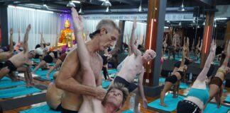 Certified yoga teacher leading a studio group class in a full room, the most common entry-level paid format for new yoga instructors starting their career