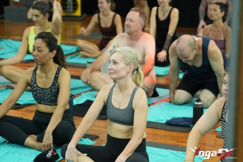 How to Choose a Yoga Teacher Training Program: What Actually Matters 3 YogaFX 200-hour yoga teacher training graduates holding their RYT 200 and Bikram Hot 26&2 dual certification after completing the intensive Bali program.
