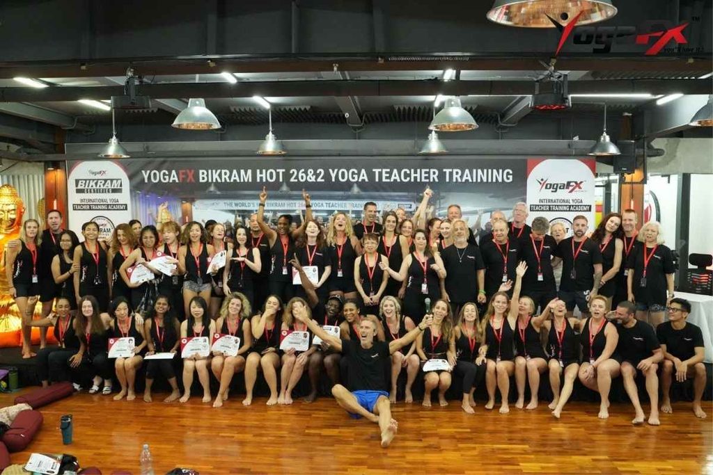 How to Apply for Bikram Yoga Teacher Training in Bali: Step-by-Step 3 Graduating trainee at the YogaFX studio in Seminyak, Bali holding dual Yoga Alliance RYT 200 and Bikram Hot 26&2 certification after completing the intensive.