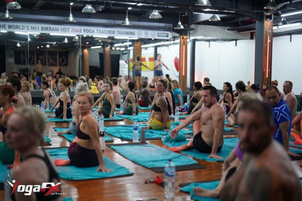 Bikram Yoga Instructor Course: Curriculum, Format & Certification 2 Small group of Bikram yoga instructor course students drilling the scripted Hot 26&2 dialogue delivery during YogaFX teacher training.