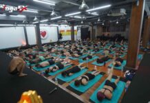 Indian student practicing Bikram Hot 26&2 posture in natural tropical heat at YogaFX Bali studio