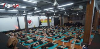Indian student practicing Bikram Hot 26&2 posture in natural tropical heat at YogaFX Bali studio