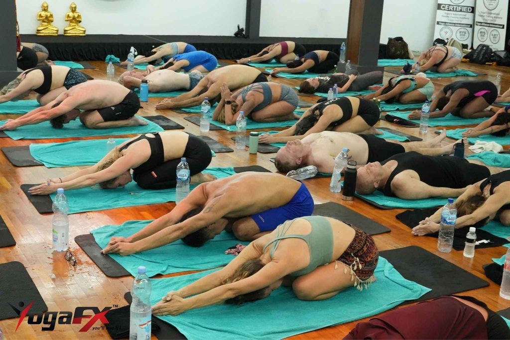 Bikram Yoga Teacher Training for US Students: Why Bali Beats a Local Program 2 Small cohort of YogaFX teacher training students practicing in natural tropical heat, Seminyak studio