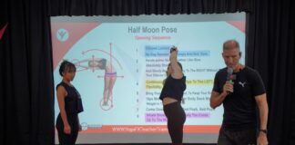 Mr Ian Terry teaching the Half Moon Pose dialogue from a projected script while a trainee demonstrates the posture