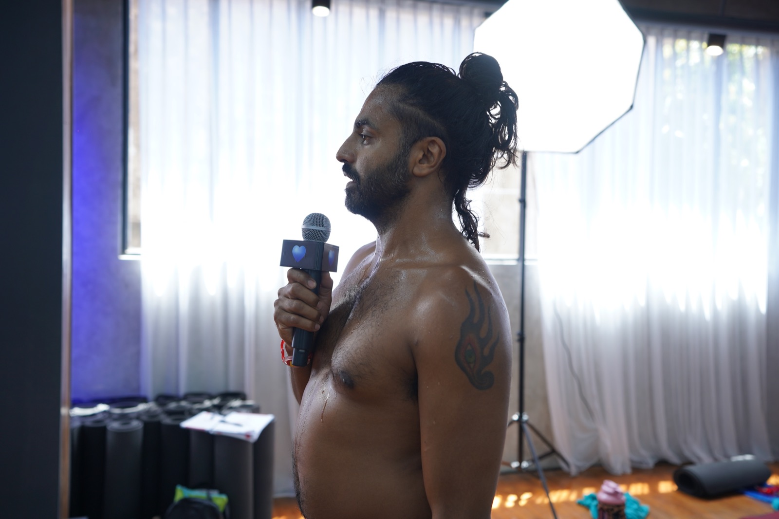How Many Men Do Yoga? The Rise of Men in the Hot Room Report 1 A male trainee speaking into a handheld microphone as he delivers the 26 and 2 dialogue during practical teaching