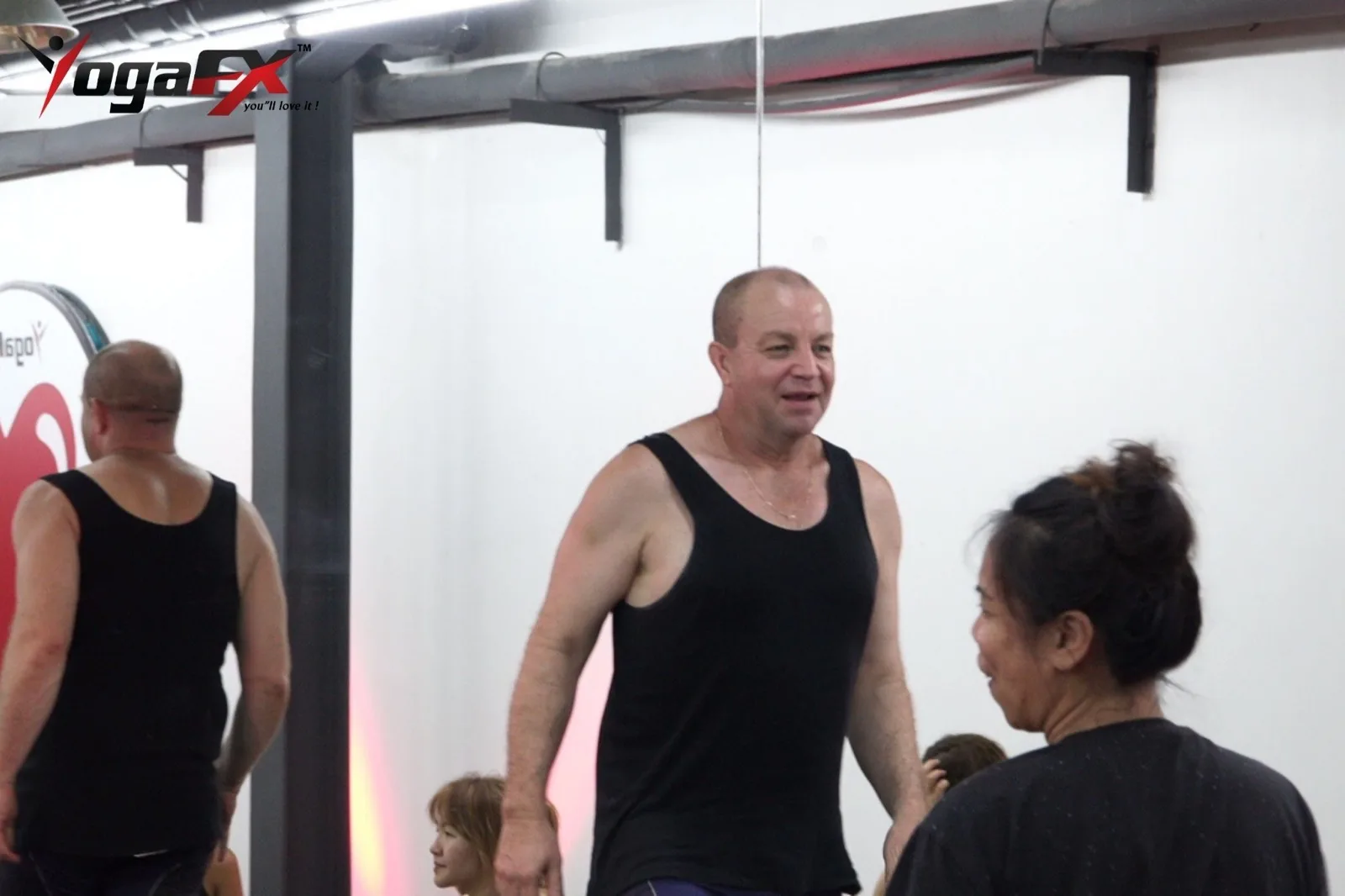 What Is a Male Yoga Teacher Called? Yogi, Instructor and RYT 200 1 A male yoga teacher trainee smiles between practice sessions during hot yoga teacher training in Bali