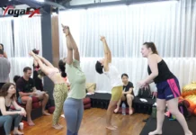 What Is a Male Yoga Teacher Called? Yogi, Instructor and RYT 200 Trainees practise teaching a standing backbend while a classmate gives instruction, part of what a male yoga teacher called an instructor learns in training